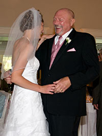 Pancreatic cancer researcher Kirsten Bryant, PhD, and her father, the late Bernie Elzer Jr., dance at her wedding. Elzer passed away from pancreatic cancer last year.